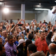 President Donald Trump tosses paper towels into a crowd as he hands out supplies at Calvary Chapel.